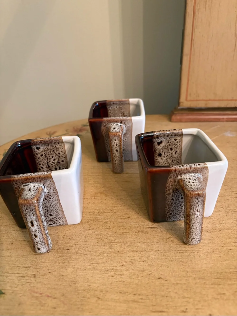Pier 1 Imports tricolor stoneware square espresso mugs in brown, white, and tan.